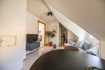 a living room with a couch and a tv at 3BR loft-apartment near Downtown & Ocean in Bergen