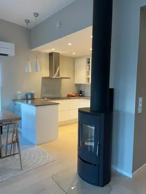 a kitchen with a stove in a living room at Semi-detached house with lovely views of the city fjord in Askøy