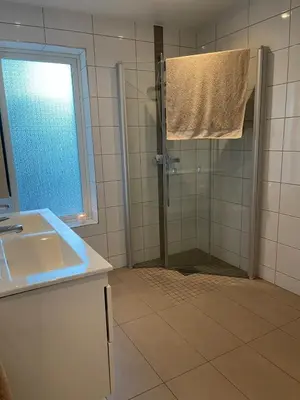 a bathroom with a shower and a sink at Semi-detached house with lovely views of the city fjord in Askøy