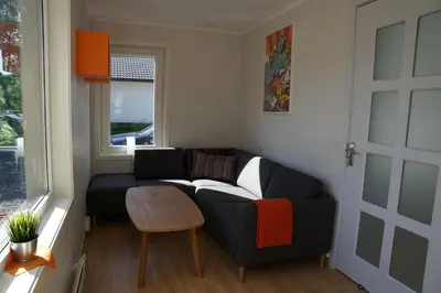 a living room with a couch and a table at Atlanten Turistsenter in Kristiansund