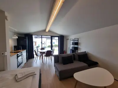 a living room and kitchen with a couch and a table at Atlanten Turistsenter in Kristiansund