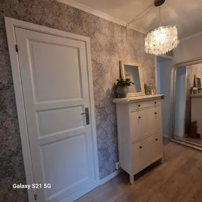 a room with a door and a dresser and a mirror at Quiet home with garden in Bergen