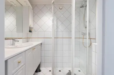 a bathroom with a shower and a sink at Nice apartment with stunning view over Bryggen in Bergen