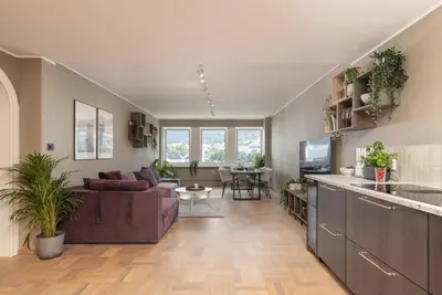 a living room with a couch and a table at Nice apartment with stunning view over Bryggen in Bergen