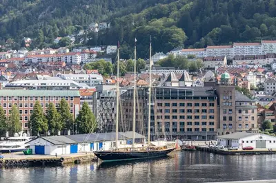 a sail boat docked at a dock in a harbor at Nice apartment with stunning view over Bryggen in Bergen
