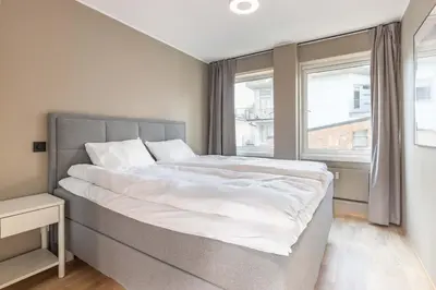 a bedroom with a large bed and a window at Nice apartment with stunning view over Bryggen in Bergen