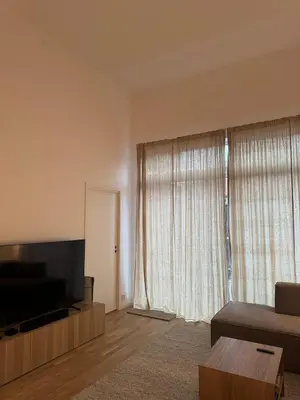 a living room with a flat screen tv and a couch at Oceanfront Stay, Large Balcony and Rooftop Access in Bergen