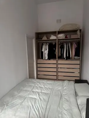 a bedroom with a bed and a closet at Oceanfront Stay, Large Balcony and Rooftop Access in Bergen