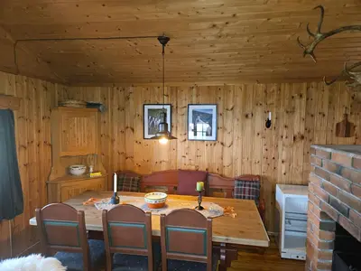 a dining room with a wooden table and chairs at Authentic Secluded Mountain Cabin in Telemark with Panoramic Views