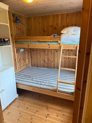 a room with two bunk beds in a cabin at Fantastic cabin in the woods & boat for rental or 2 days free boat on 7 days stay