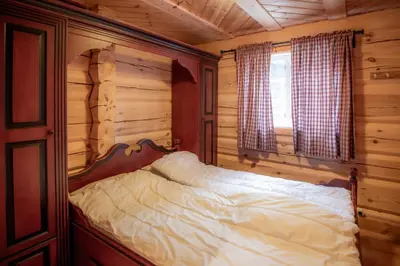 a bedroom with a bed in a log cabin at Trysilfjellet Sør 802 in Trysil
