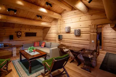 a log cabin living room with a couch and a table at Trysilfjellet Sør 802 in Trysil