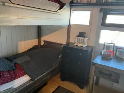 a bedroom with a bunk bed and a desk at Ski in ski out in Geilo, comfortable and family friendly cabin in Geilo