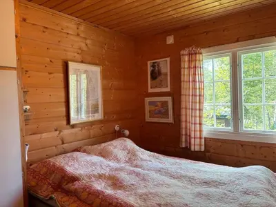a bedroom with a bed in a log cabin at Geilo - Hyggelig og sentral hytte in Hol