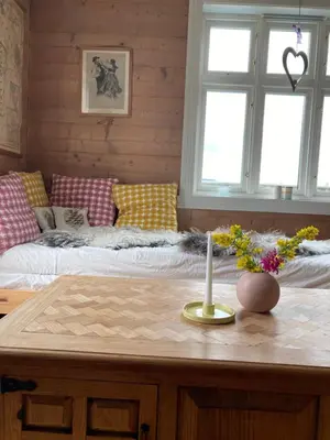 a room with a bed and a table with a candle at West coast peace in Hyllestad