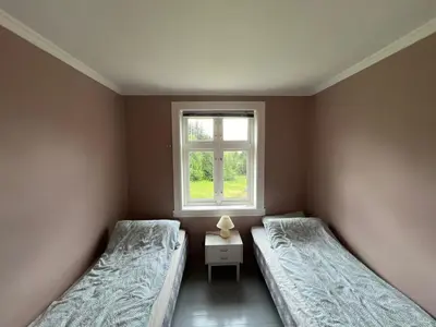 two beds in a room with a window at West coast peace in Hyllestad