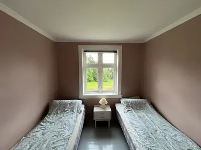 two beds in a room with a window at West coast peace in Hyllestad