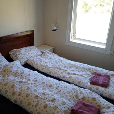 two beds sitting next to each other in a bedroom at Gullingen Cabin Winter Wonderland