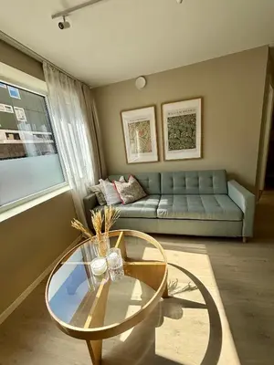 a living room with a couch and a glass table at Leilighet i Bergen sentrum in Bergen