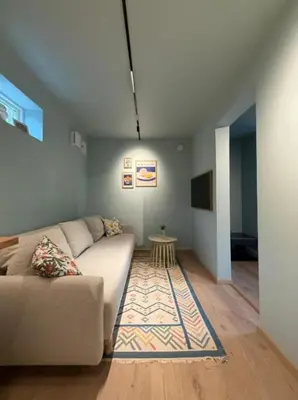 a living room with a couch and a table at Moderne leilighet in Bergen