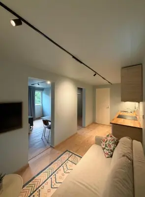 a living room with a couch and a sink at Moderne leilighet in Bergen