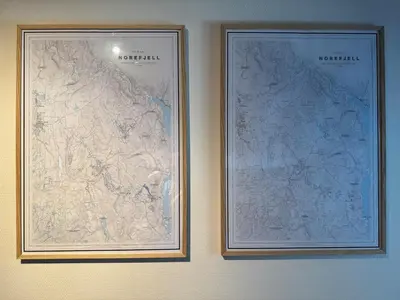 two framed maps are hanging on a wall at Norefjell Ski in - Ski out in Noresund
