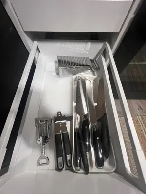 a drawer filled with kitchen utensils in a sink at Solsiden Geilo Cozy Studio location Geilo Centrum in Hol