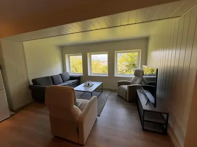 a living room with a couch and a table at The simple appartment in Stryn in Stryn