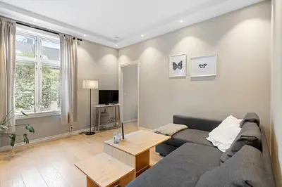 a living room with a couch and a table at Inviting & Cozy City Apartment in Bergen