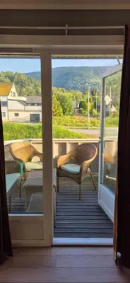 a screened in porch with a view of the mountains at Central Langevåg Family Apartment in Sula