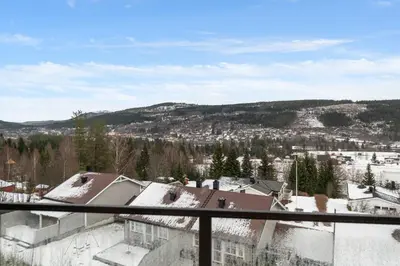 a view of a city from the balcony of a building at Motoppen Trysil Apartments in Trysil