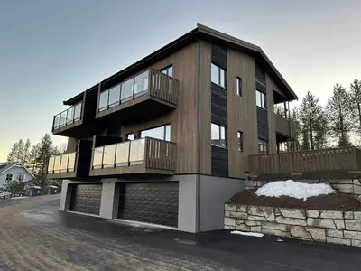 a building with a balcony on the side of it at Motoppen Trysil Apartments in Trysil