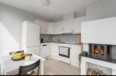a kitchen with a table with a plate of fruit on it at Munkegata 30 Trondheim in Trondheim