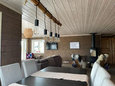 a dining room with a table and a dog sitting on the couch at Annebu by Norgesbooking - cabin at 1000 meter with amazing view in Ål