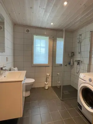 a bathroom with a toilet and a sink and a washing machine at Annebu by Norgesbooking - cabin at 1000 meter with amazing view in Ål