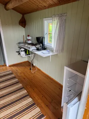 a small kitchen with a counter and a window at Sjøbakken Fjord Camping AS in Sykkylven