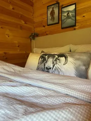 a goat standing on a bed in a bedroom at Hytte med panoramautsikt i Uvdal in Nørdstebø