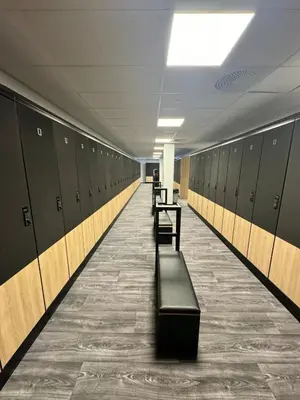 a long hallway with lockers and a table and benches at Trysil Alpine Lodge - 510 in Trysil