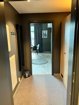 a hallway with a door leading to a living room at Trysil Alpine Lodge - 510 in Trysil