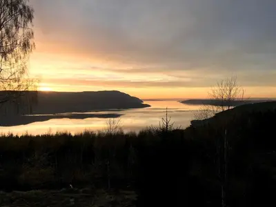 a view of a body of water at sunset at Villa Fjara sleeps 34 in Stange