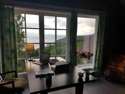 an office with a desk with a laptop and a large window at Villa Fjara sleeps 34 in Stange