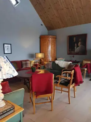 a living room with a couch and a table at Villa Fjara sleeps 34 in Stange