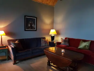a living room with two couches and a coffee table at Villa Fjara sleeps 34 in Stange