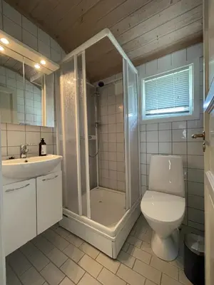 a bathroom with a shower and a toilet and a sink at Revehiet - 3 bedroom cabin in the center of Geilo in Geilo