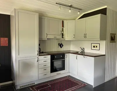 a white kitchen with white cabinets and a sink at Revehiet - 3 bedroom cabin in the center of Geilo in Geilo