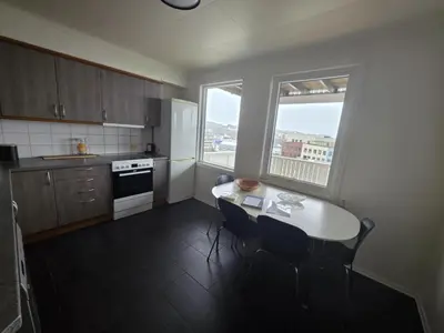 a kitchen with a table and two chairs and a window at Best flat in town in Kristiansund
