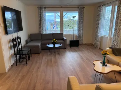 a living room with a couch and a table at Best flat in town in Kristiansund