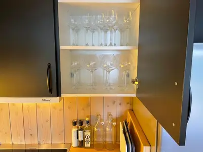 a cabinet filled with wine glasses and bottles at Fantastisk utsikt i Hemsedal med ski in og ski ut in Fausko