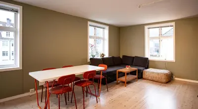 a living room with a couch and a table and chairs at Quiet place near city centre and the mountains in Bergen