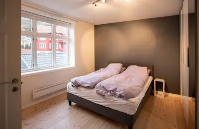 a bed in a room with a window at Quiet place near city centre and the mountains in Bergen